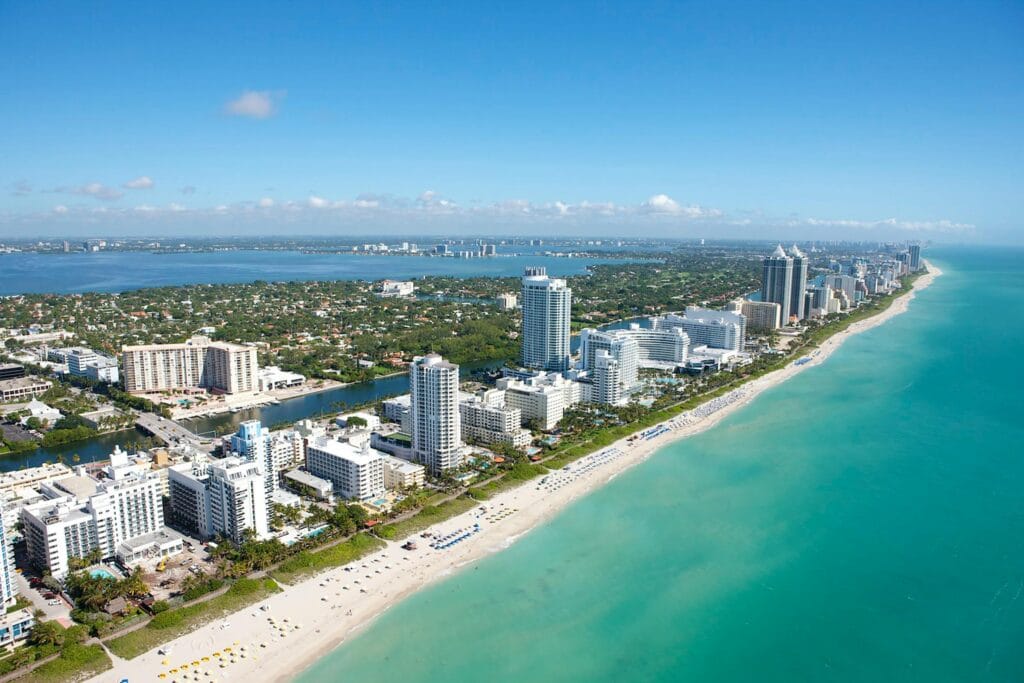Stunning aerial view of Miami Beach's skyline along the Atlantic Ocean, ideal for travel and adventure imagery. Florida Permit Expeditor