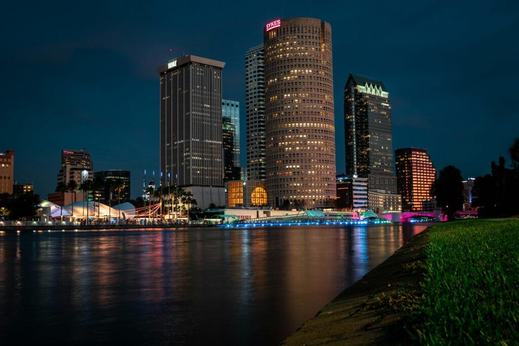 Explore Tampa's stunning evening skyline reflected on the calm river.